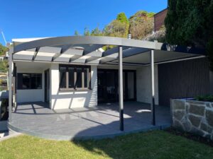 Installed and painted curved treated pine glulam pergola beam